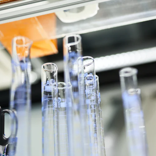 Multiple transparent test tubes in laboratory.
