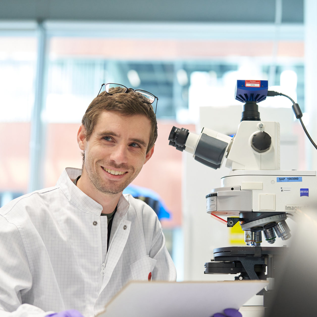 Male scientist working on the microscope in the PMI laboratory, Cube