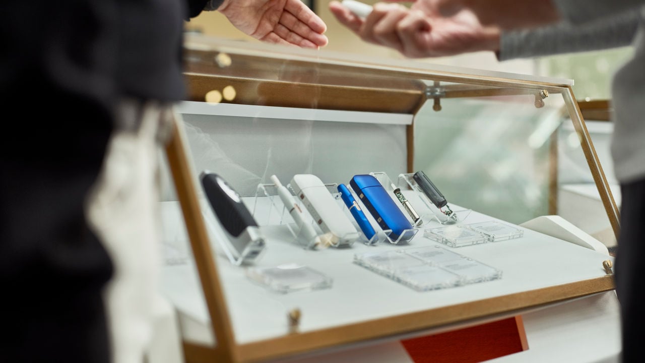 Smoke-free products displayed in glass vitrine.