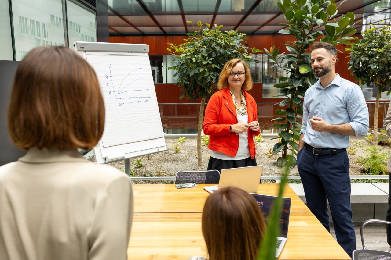 Team standing in front of white chart