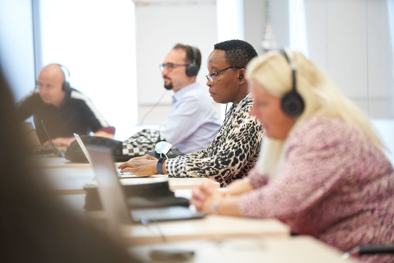 People with headphones working