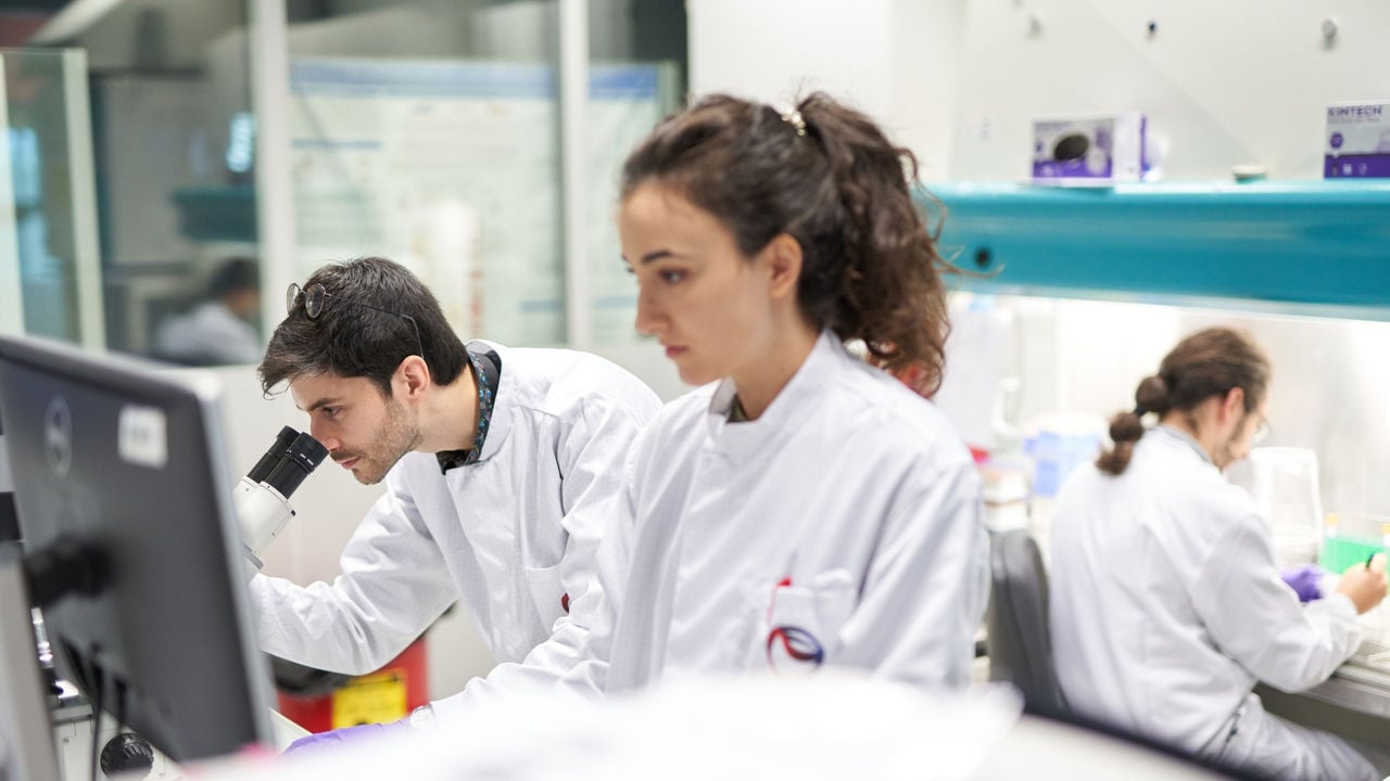 Scientist wearing a white lab coat working in a laboratory.