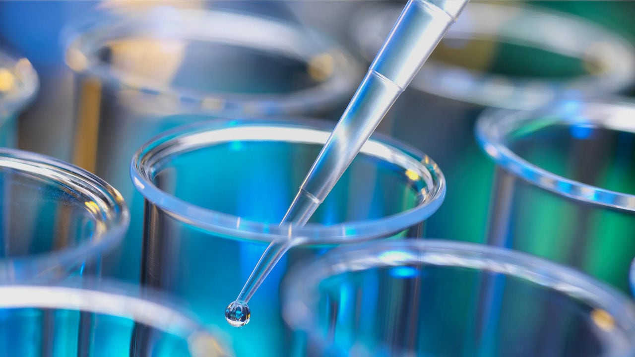 Glass equipment and pipette in a laboratory setting, representing harm reduction research efforts.