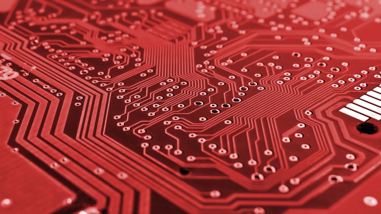 Close-up view of a red electronic circuit board.