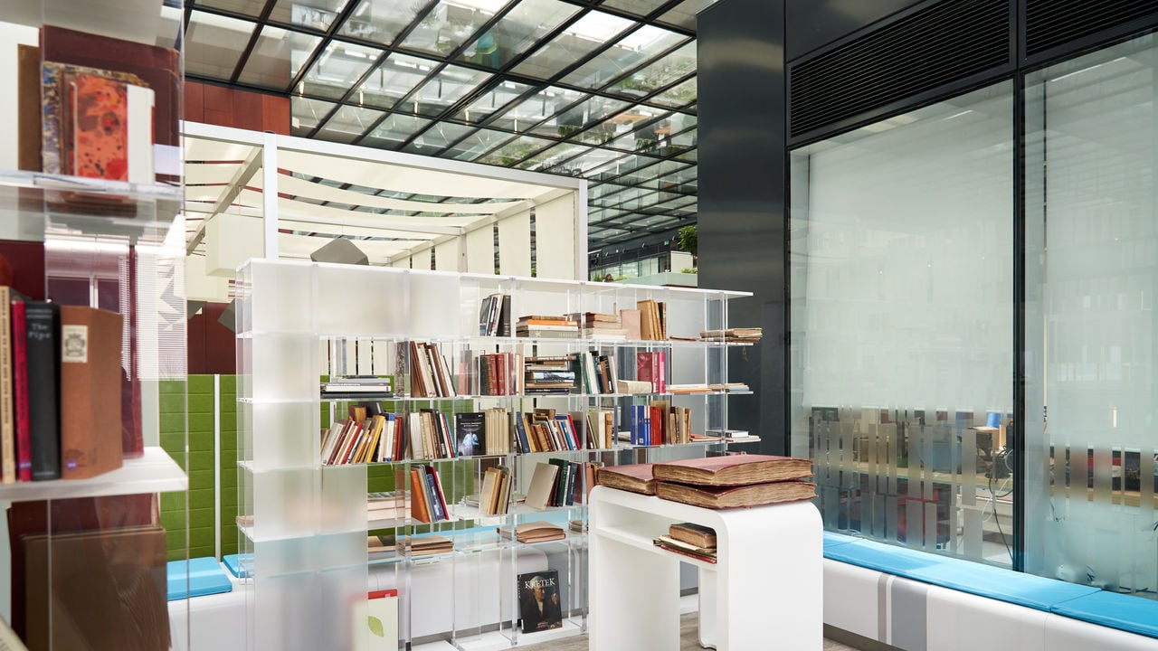 Collection of books on a bookshelf inside the Cube, PMI's research and development center.