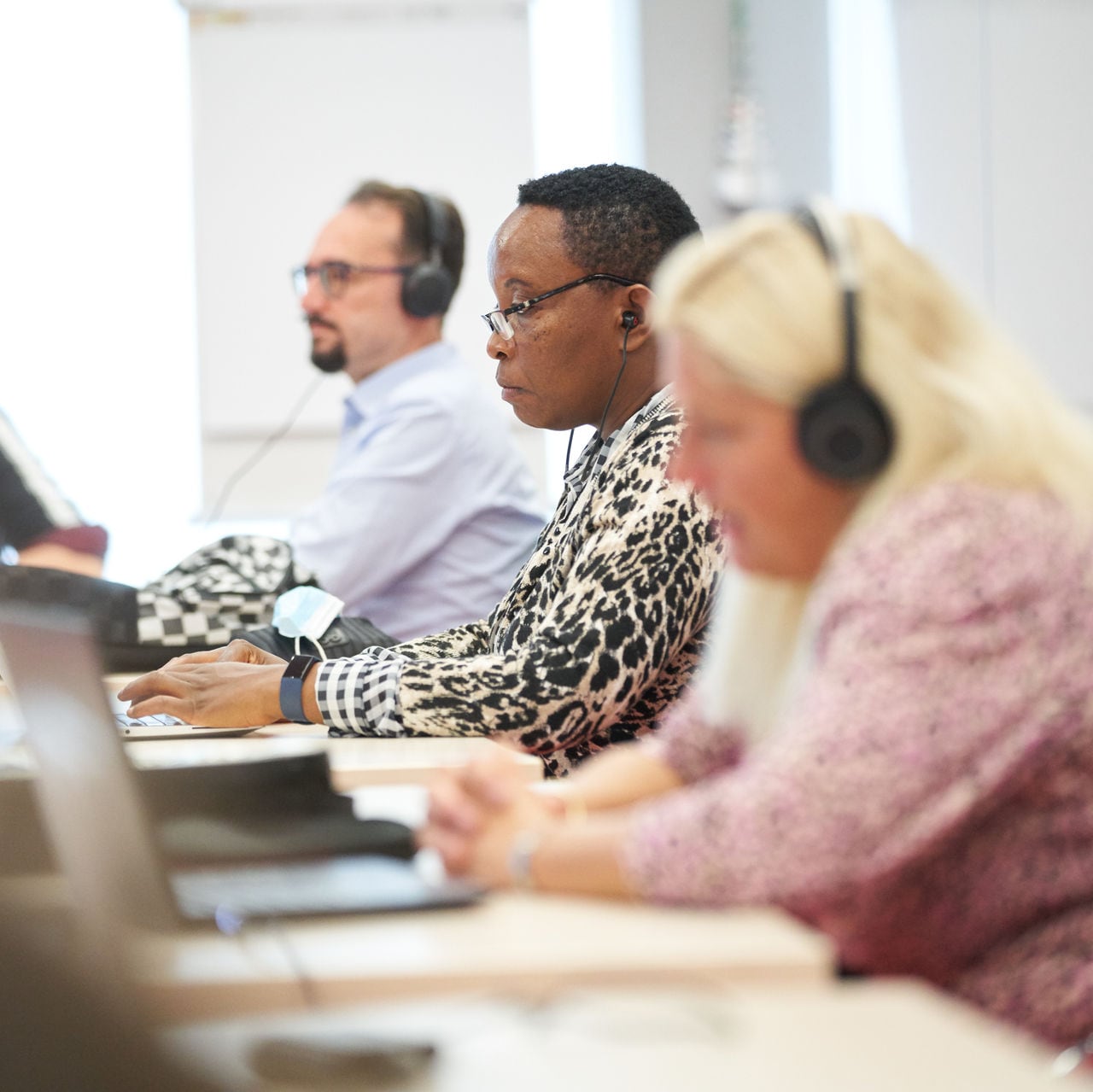 People with headphones working
