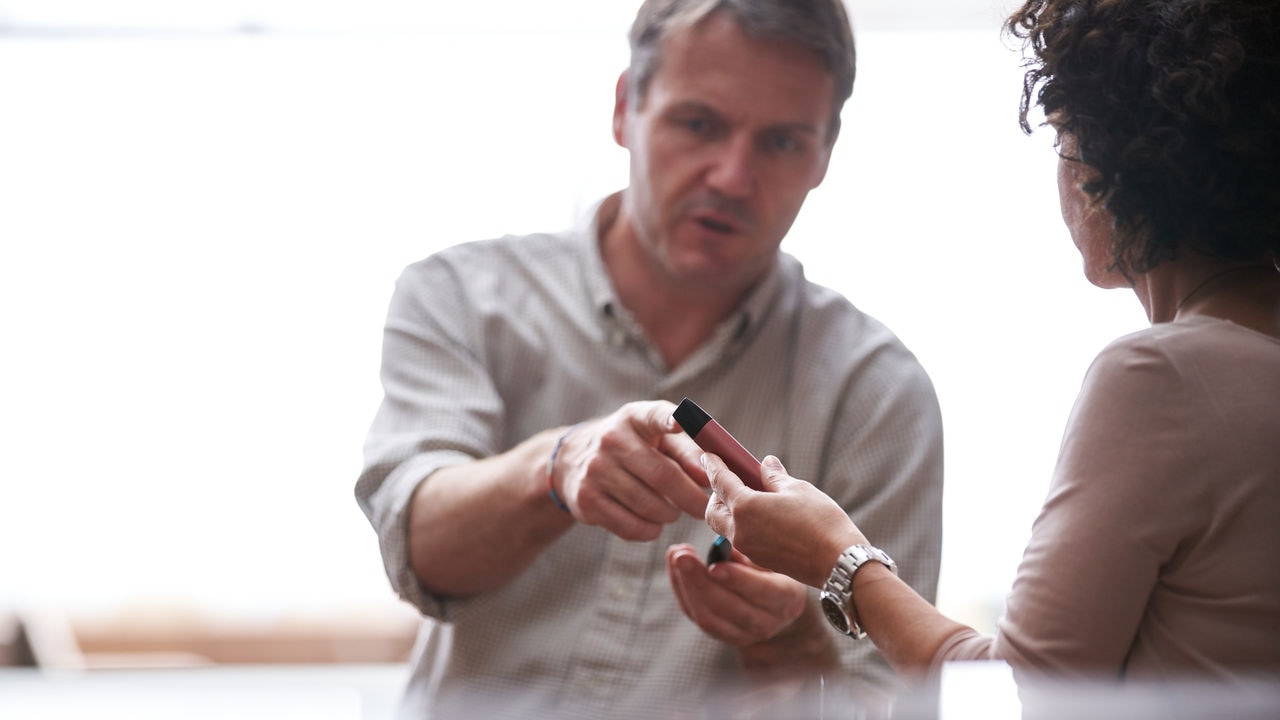 Two people discussing PMI smoke-free products