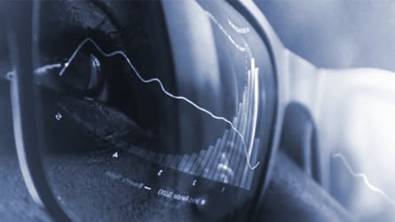 Detailed view of an individual wearing high-tech glasses with screen reflection in the lens.