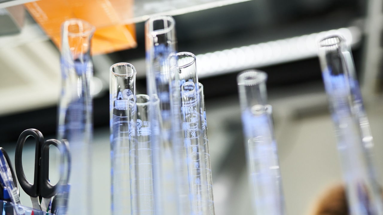 Transparent tubes at laboratory desk.